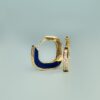 Elegant gold hoop earrings featuring blue enamel and sparkling diamonds, showcasing modern jewelry design.