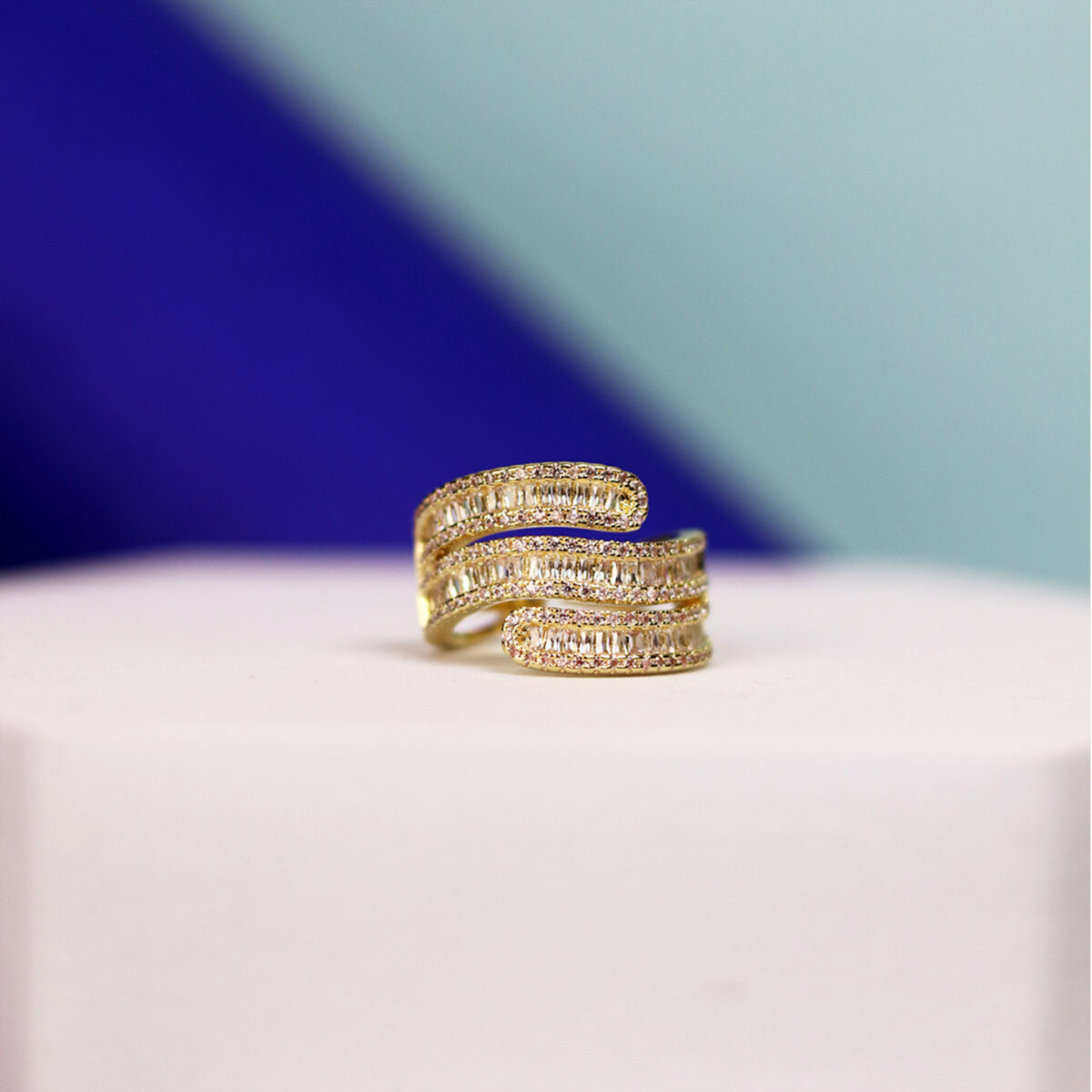 Gold ring featuring a spiral design with multiple bands and intricate detailing.