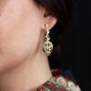 Elegant gold drop earrings featuring intricate design and sparkling crystals, perfect for adding a touch of glamour to any outfit.