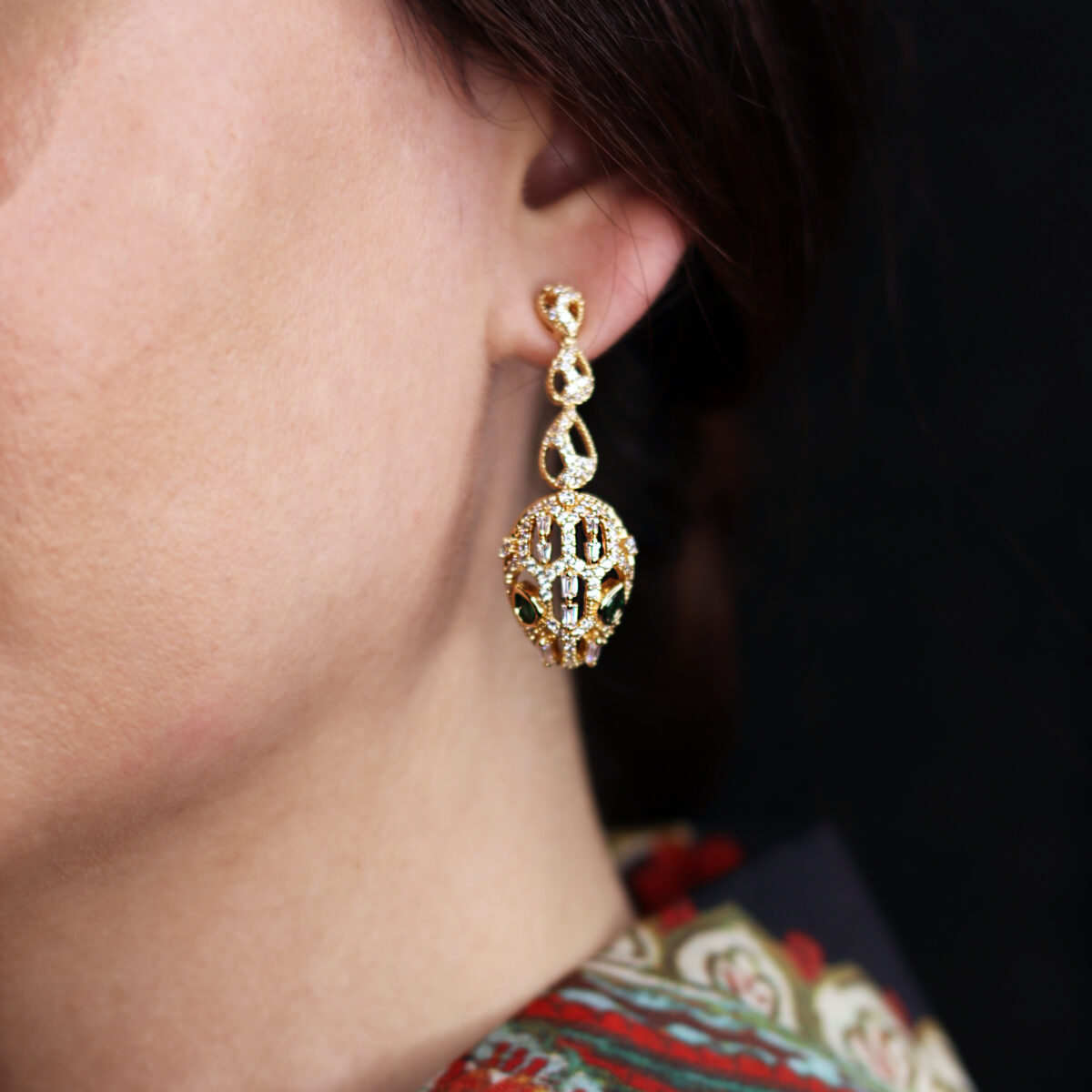 Elegant gold drop earrings featuring intricate design and sparkling crystals, perfect for adding a touch of glamour to any outfit.