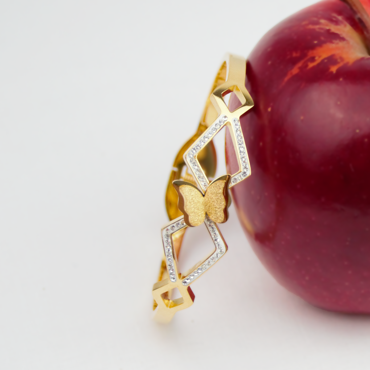 Gold butterfly bracelet featuring gemstones and intricate design, showcasing elegance and style for jewelry enthusiasts.