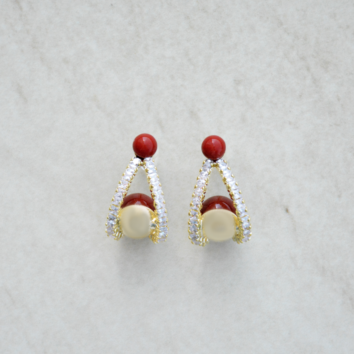 Stylish red and pearl earrings with a sparkling design featuring gold accents and rhinestones, perfect for any occasion.